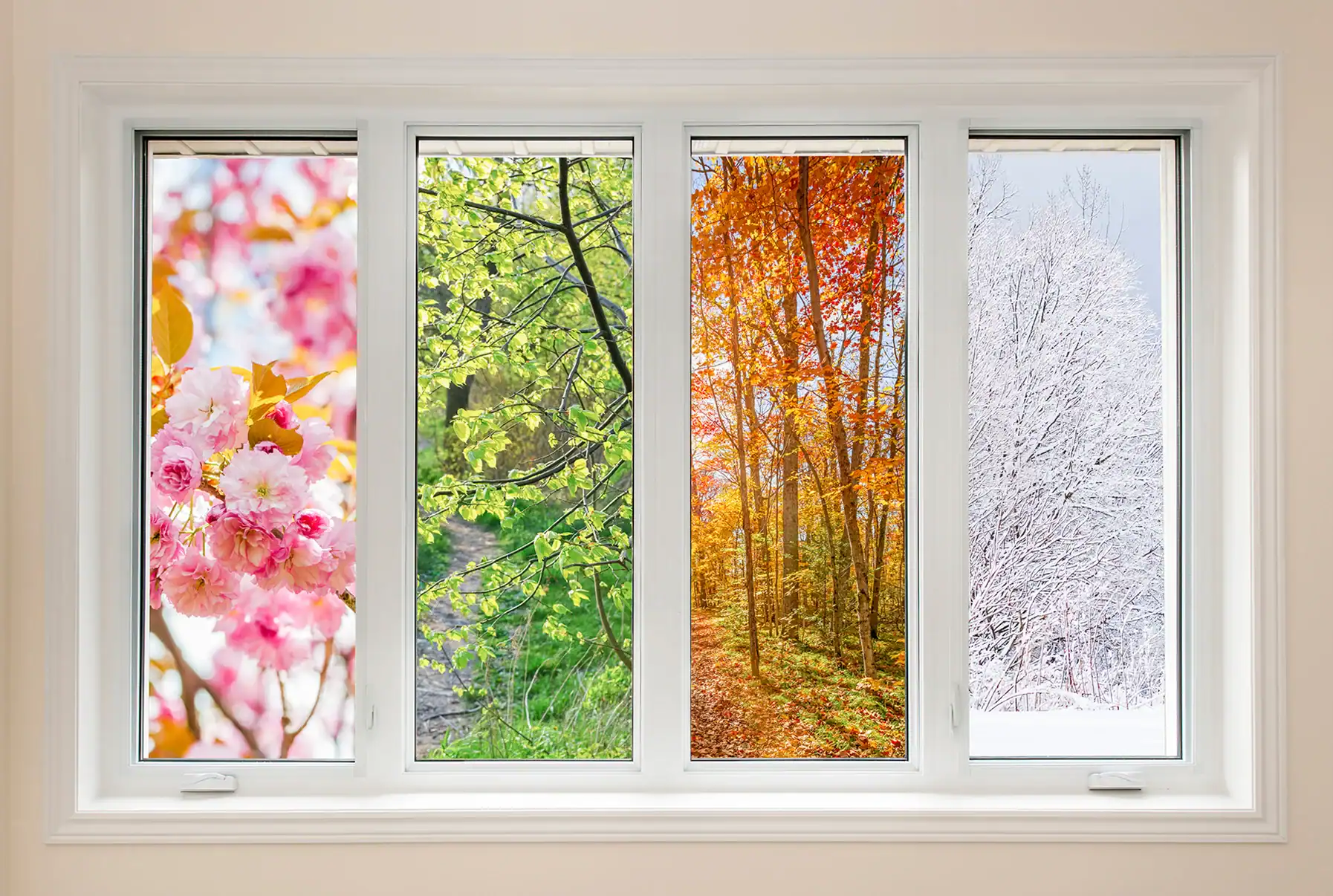 A white-framed window with four panes, each showing a different season&mdash;spring blooms, summer greens, autumn orange leaves, and winter snow&mdash;is the perfect inspiration for your Complete Guide to Replacing Windows.
